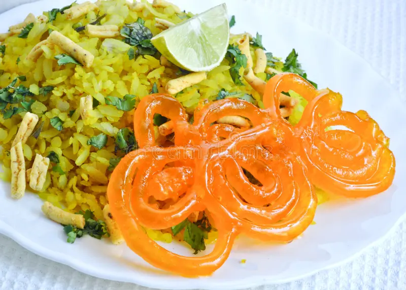 Classic Bhopal breakfast combo of poha (flattened rice) and crispy jalebis, served hot.