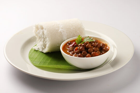Steamed Puttu with Kadala Curry, a classic Kerala breakfast dish.