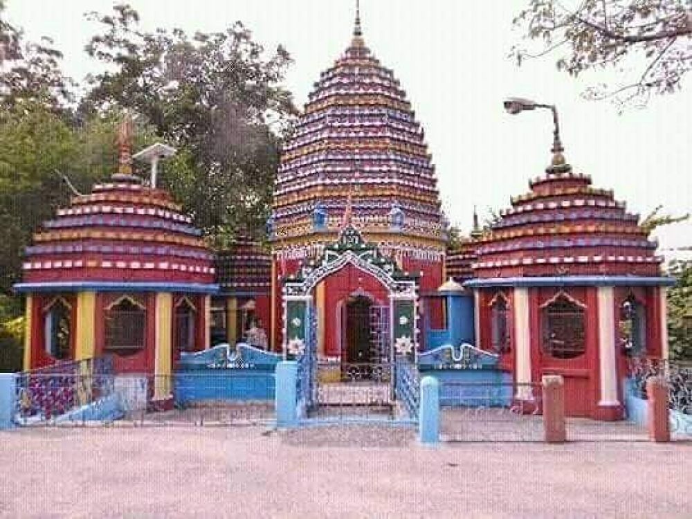 Ancient temple beside cascading waterfall