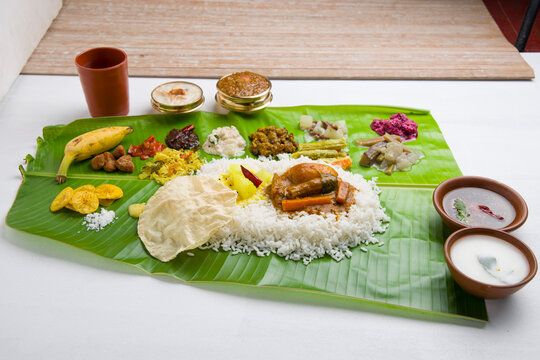 Traditional Kerala Sadya feast served on banana leaf with vegetarian delicacies.