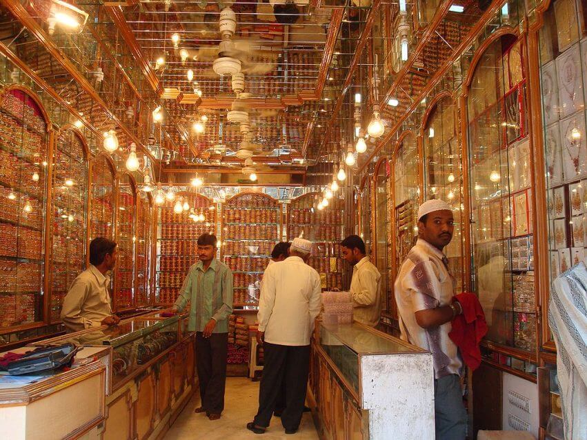 Night food market with glittering jewelry shops by day