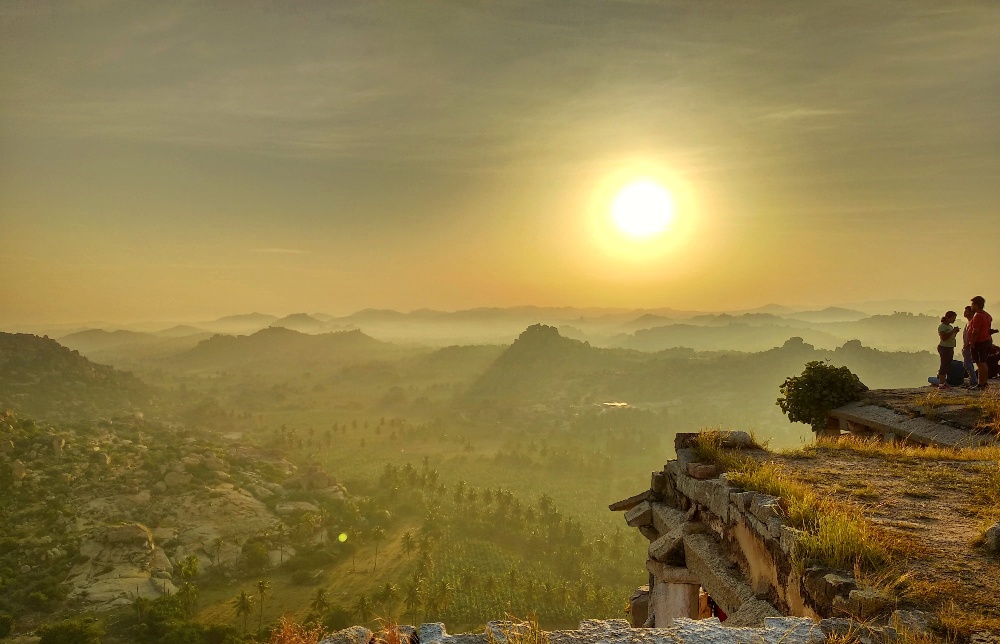 Tourists watching sunset from Hemakuta Hill in Hampi