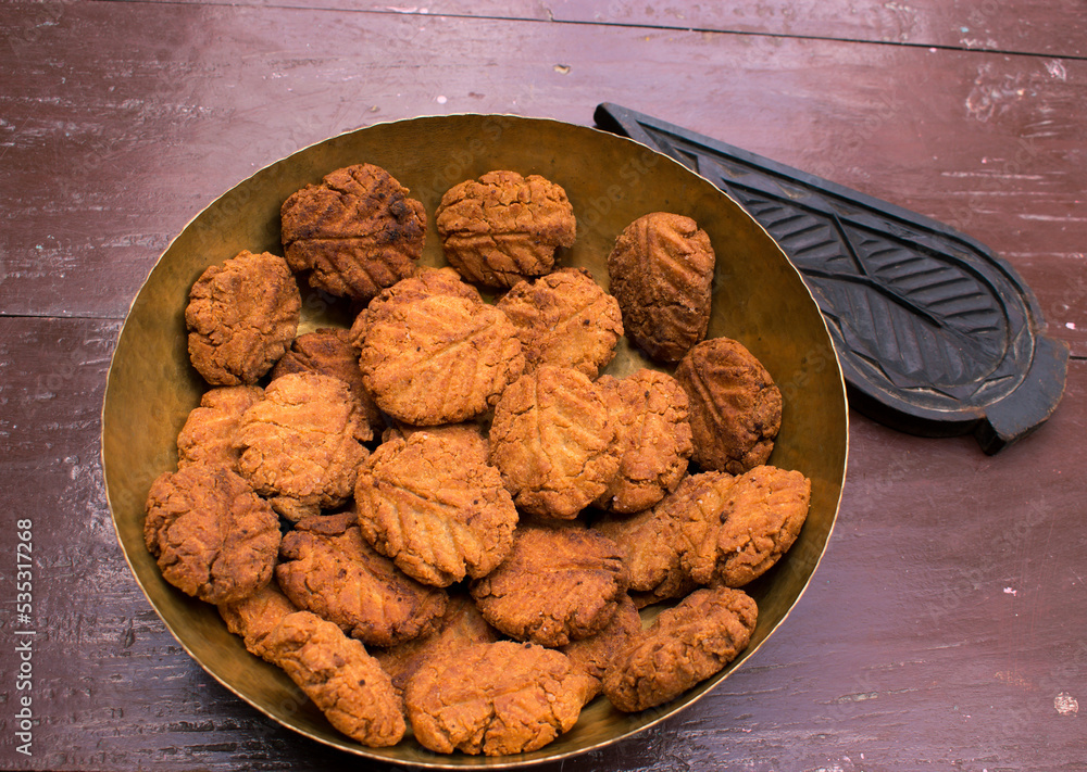 Crispy golden Thekua sweets arranged in a basket