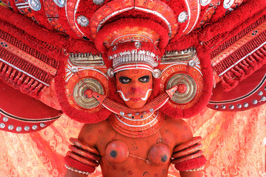 Ritualistic Theyyam performance with vibrant costumes and divine expressions.