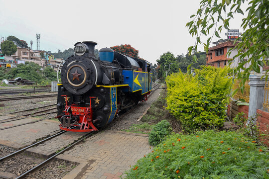 Children waving from the Nilgiri toy train, a joyride on Ooty City Page.