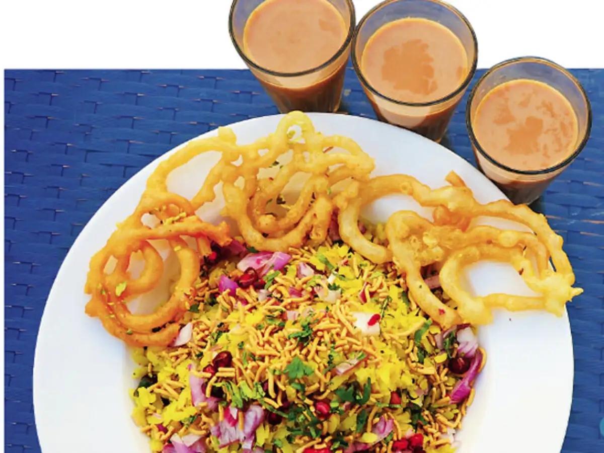 A vibrant spread of authentic Bhopali cuisine, featuring poha-jalebi, kebabs, and Shahi Tukda, showcasing the rich Nawabi flavors of Bhopal.