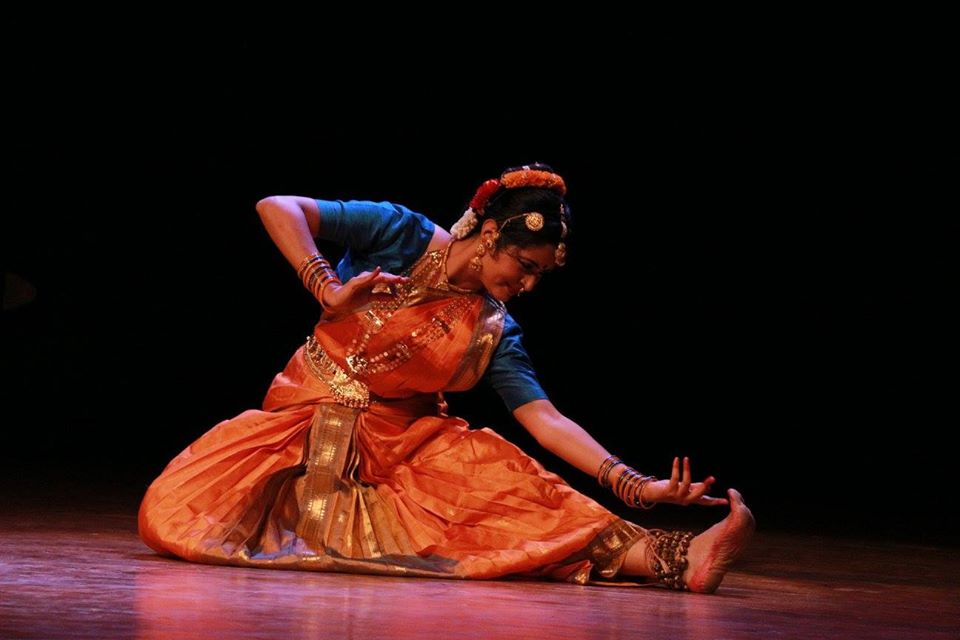 Graceful Vilasini Natyam performer with temple backdrop.