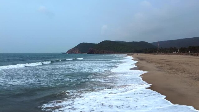Golden sands meeting turquoise waves at Yarada Beach, a hidden coastal gem on our city page Visakhapatnam travel guide.