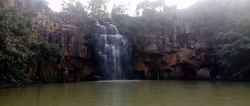Picturesque waterfall with rocky cliffs, great for short hikes and photography.