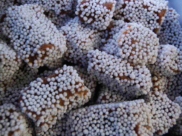 Squares of Bal Mithai coated in sugar balls