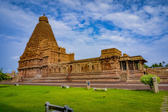 The towering 11th-century Brihadeeswarar Temple, a UNESCO World Heritage Site, with its massive granite vimana (tower), intricate Chola-era sculptures, and the sacred Nandi bull statue in the foreground.