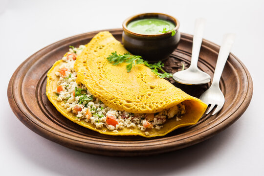 Golden-brown Chila, a savory rice pancake served with chutney
