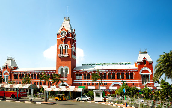 Dr. M.G. Ramachandran Central Railway Station entrance with passengers boarding trains, featuring clear signage and wheelchair-accessible ramps.