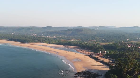Tranquil Guhagar Beach with soft sands and swaying palm trees.