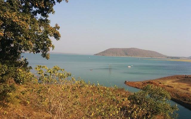 Serene Pakhal Lake in Warangal, surrounded by lush forests and wildlife.