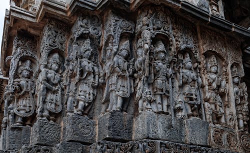 Close-up of detailed sculptures in Halebidu’s temple corridors