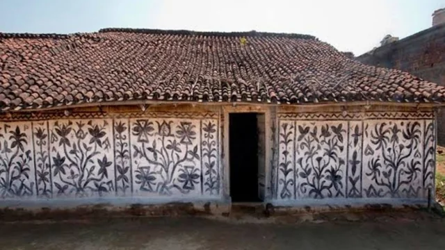 Traditional tribal wall paintings featuring geometric and animal motifs.