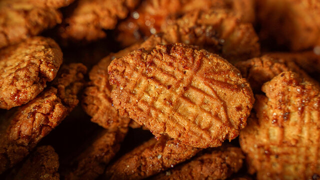 A close-up of golden-brown Thekua sweets, a popular snack.