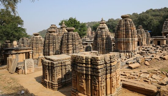 A wide shot of the numerous ancient Shiva temples lining the banks of the Yamuna River.