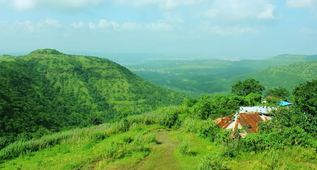 A panoramic view of the lush, green Western Ghats mountain range, a UNESCO World Heritage Site.