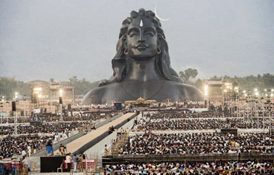 The massive face of the Adiyogi statue against the sky.
