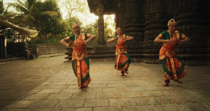 Dancer in a colorful costume performing Bharatanatyam, a classical Indian dance.