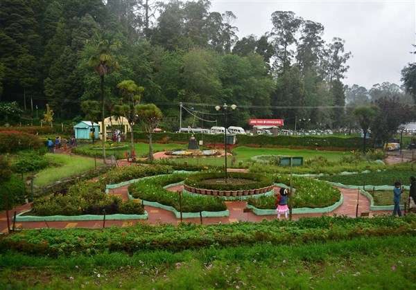 A vibrant flowerbed displaying colorful blooms in the well-maintained Bryant Park gardens, a beautiful place to visit in Kodaikanal.
