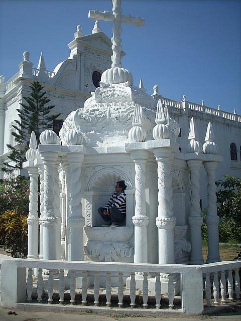 The historic white facade of the Church of Our Lady of the Rosary, nestled within the walls of Moti Daman Fort.