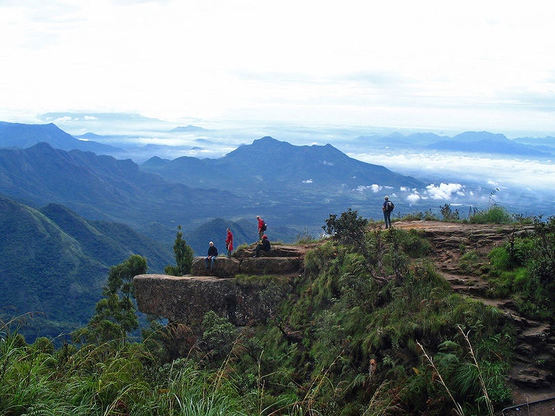 A panoramic vista of the deep valley and plains seen from the tip of Dolphin's Nose in Kodaikanal.