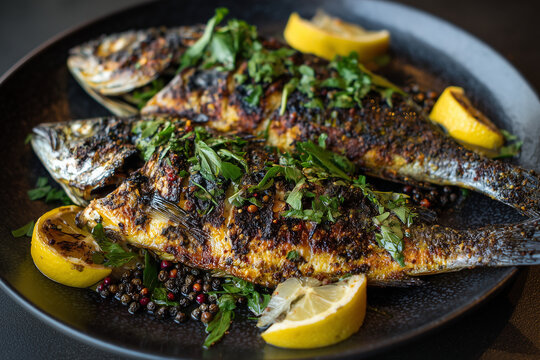 A sizzling plate of Fresh Fish Fry, seasoned with local spices and served with lemon.