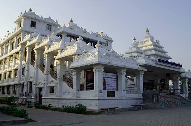 The ornate white and gold main building of the ISKCON Temple in Chennai.