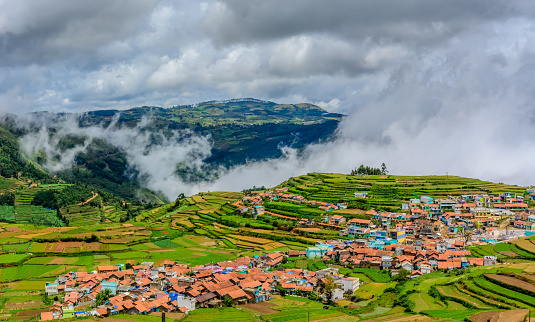 A layered landscape of ancient agricultural terraces carved into the hillside in Kavunji.