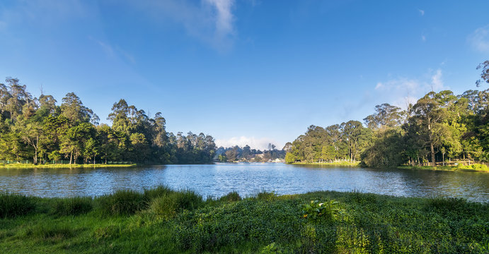 A serene view of the star-shaped Kodaikanal Lake surrounded by lush green hills.
