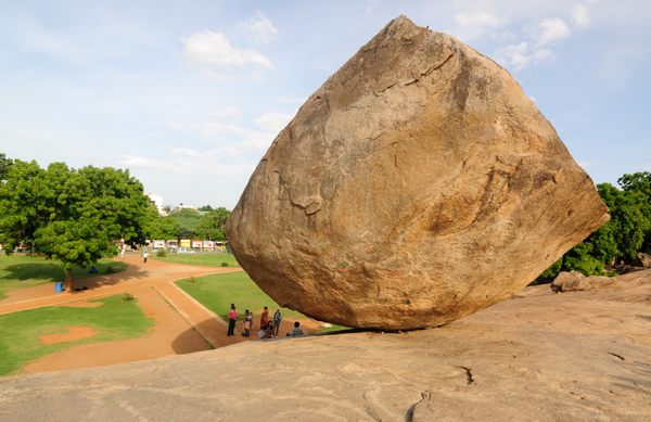 People gathered under Krishna's Butterball, a unique geological place to visit in Mahabalipuram.