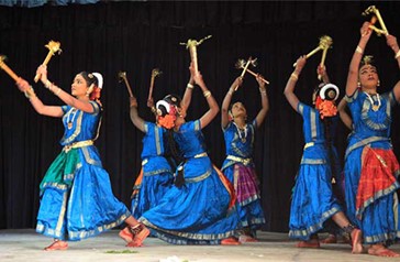 Group of women performing the folk dances Kummi and Kolattam.