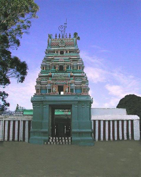 The white temple structure of Kurinji Andavar Temple set against a clear blue sky, a spiritual place to visit in Kodaikanal.