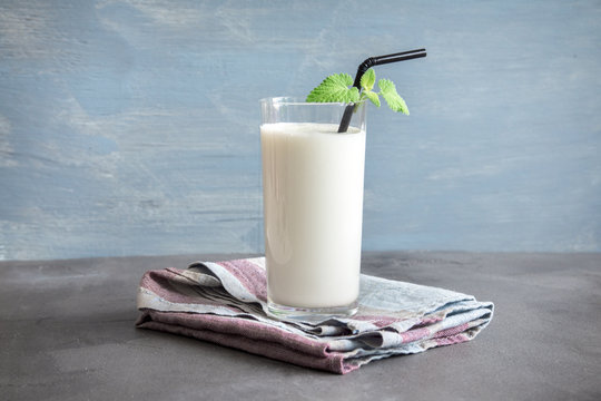 A frothy, chilled lassi served in a traditional brass glass.