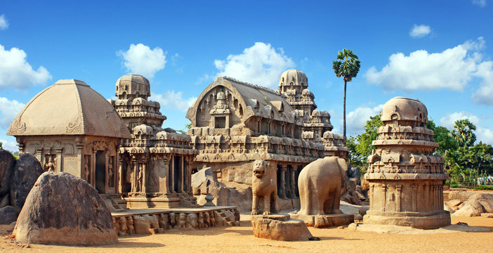A panoramic full view of the ancient stone sculptures and temples of Mahabalipuram against the backdrop of the Bay of Bengal.