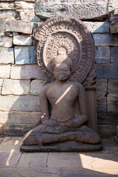 A person meditating peacefully in front of the Sanchi Stupa.