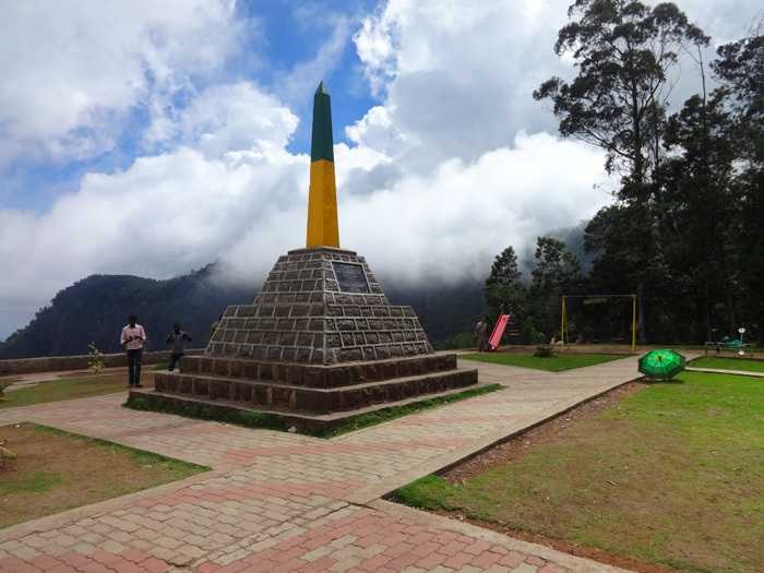 A viewpoint sign at Moir Point with visitors enjoying the vista of the surrounding hills and valley.