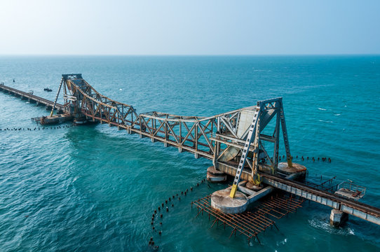 The impressive vertical-lift span of the New Pamban Bridge against a sunset sky in Rameshwaram