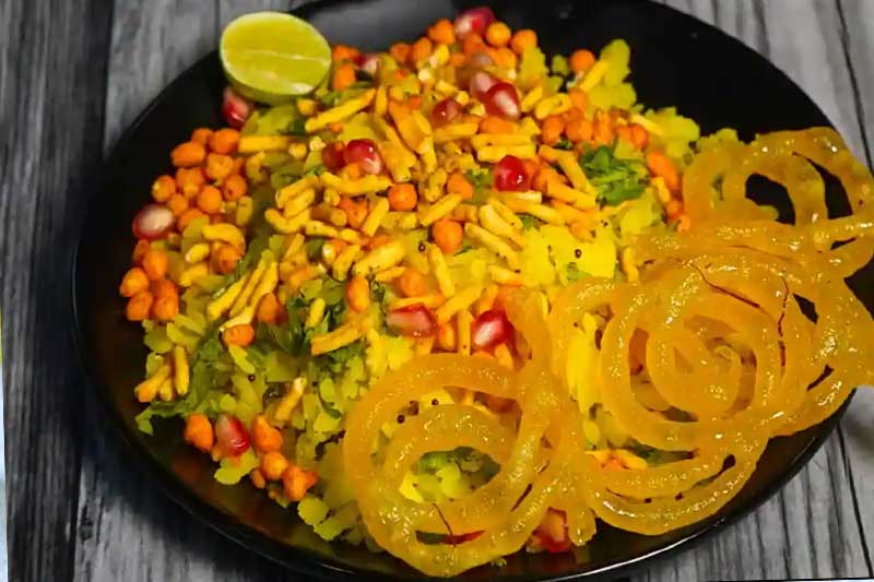 A plate of Poha served with jalebis.