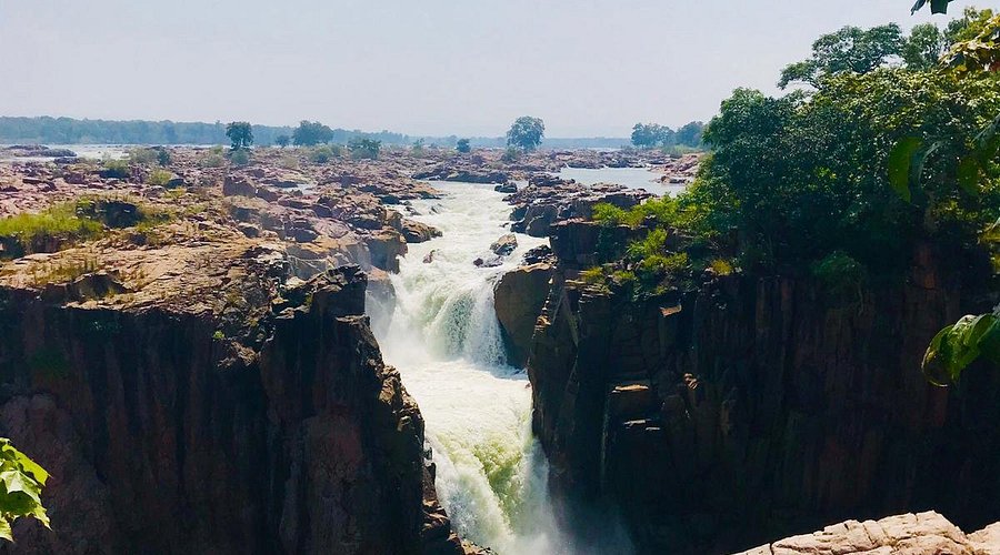 A unique canyon waterfall with water flowing over colorful crystalline rock formations, a geological wonder in Central India's Famous Waterfalls.