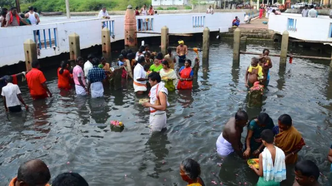 Pilgrims performing the sacred Snanam ritual at the wells in Rameshwaram.