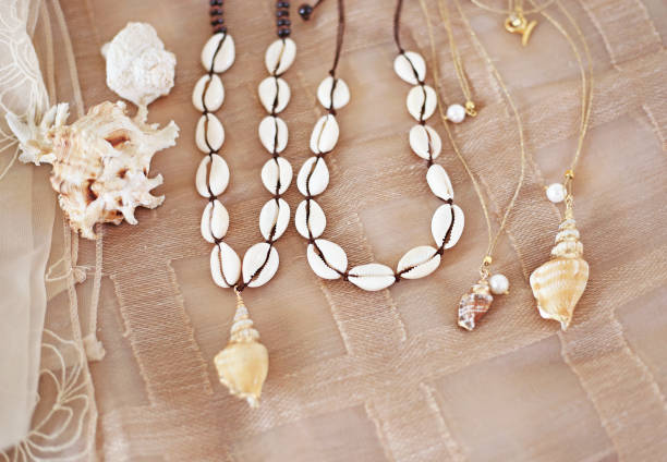Various pieces of necklaces and bracelets made from colorful seashells.