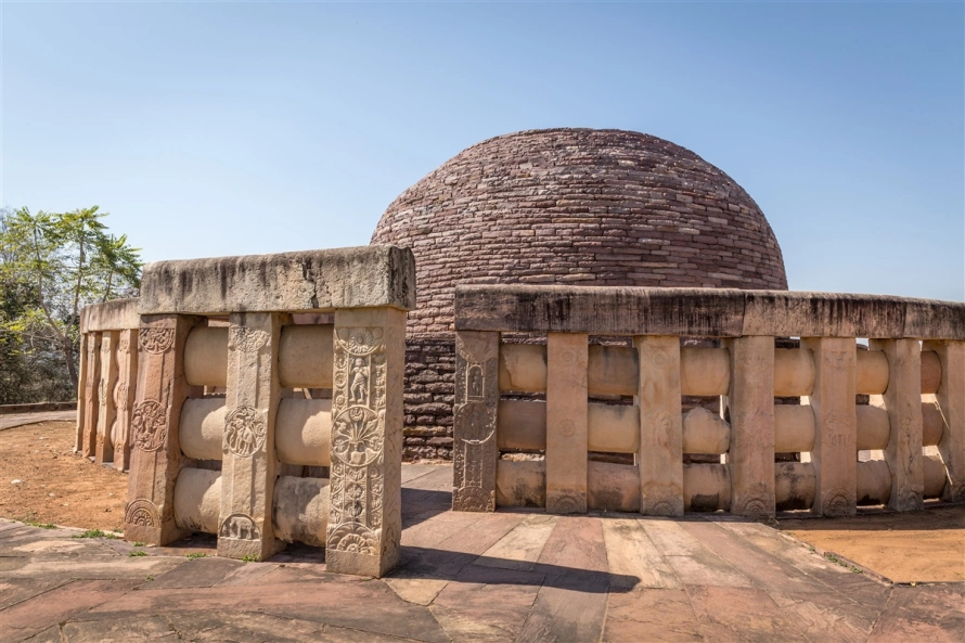 Detailed carvings on Stupa 2's railings showing Buddhist motifs at this essential place to visit in Sanchi