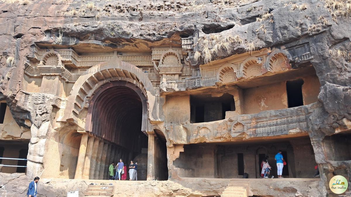 The grand, wooden-facaded entrance to the Karla Caves chaitya hall, an ancient Buddhist rock-cut site in Maharashtra.