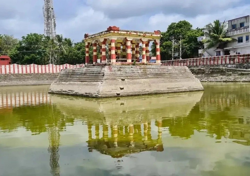 A devotee taking a holy dip in one of the 22 sacred wells, a spiritual ritual at the places to visit in Rameshwaram.