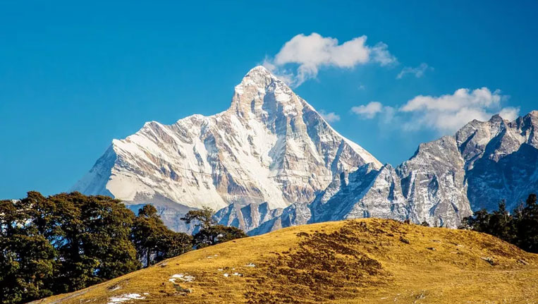 A panoramic view of the snow-covered Himalayan slopes and ski resorts in Auli, showcasing popular places to visit in Auli.