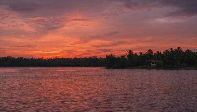 A scenic, palm-fringed backwater lagoon winding through the lush green landscape of Kerala, with traditional houseboats gliding on calm waters.